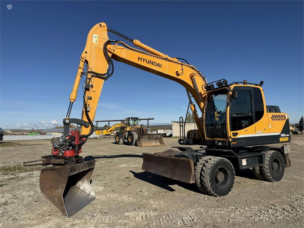 Hyundai Robex 140 W-9A Rototilt + grap - Колісний екскаватор: фото 1 Hyundai Robex 140 W-9A Rototilt + grap - Колісний екскаватор: фото 1