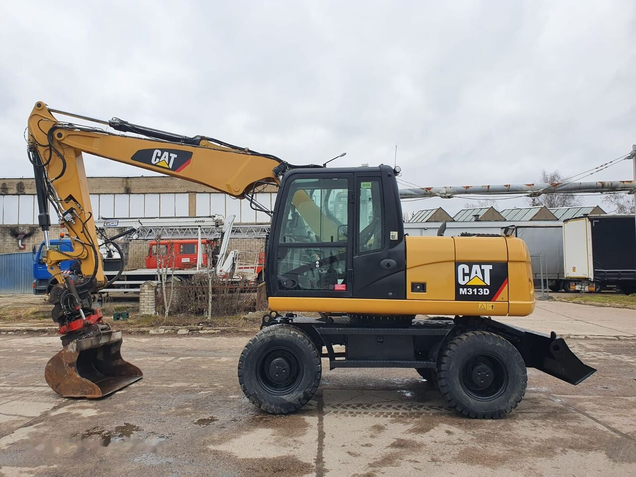 Caterpillar M 313 D Tiltrotator - Колісний екскаватор: фото 1 Caterpillar M 313 D Tiltrotator - Колісний екскаватор: фото 1